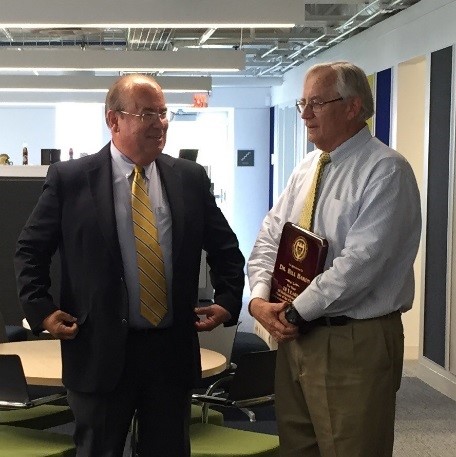 Dr. Bill Baron accepting a plaque from Mr. Steve Swant