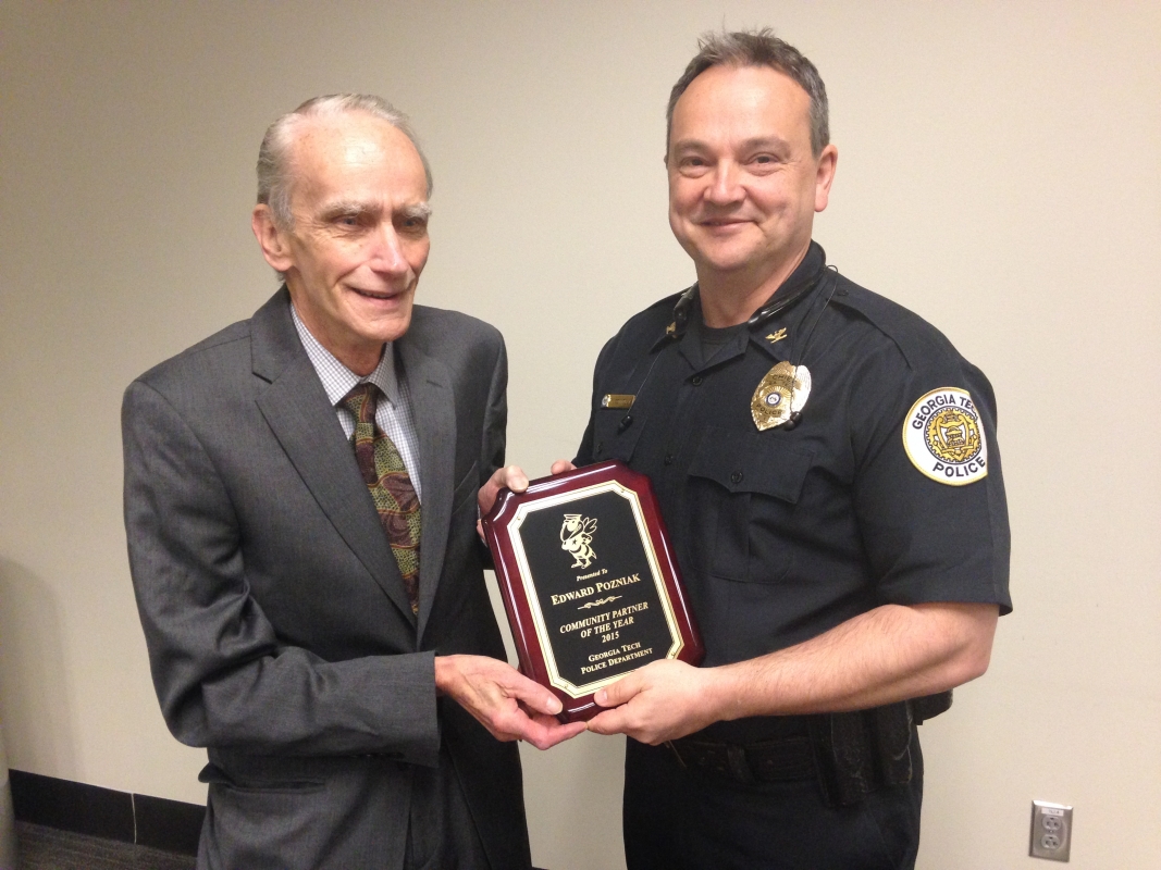 Ed Pozniak receives an award from Chief of Police Rob Connolly