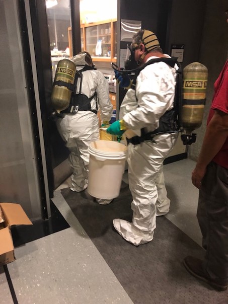 2 men wearing SCBA and spill protection