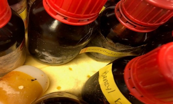 many amber chemical bottles with crystals